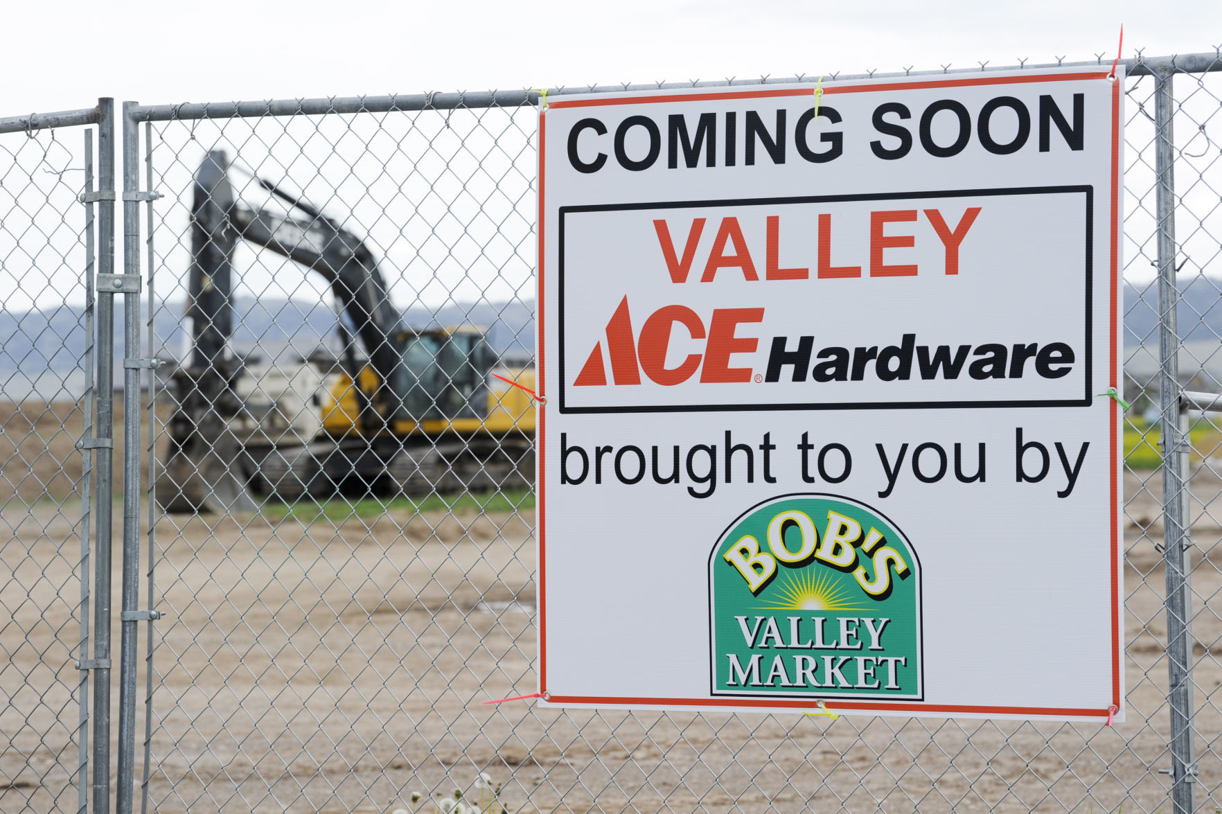A sign notifies the public of the new Valley Ace Hardware store in construction.